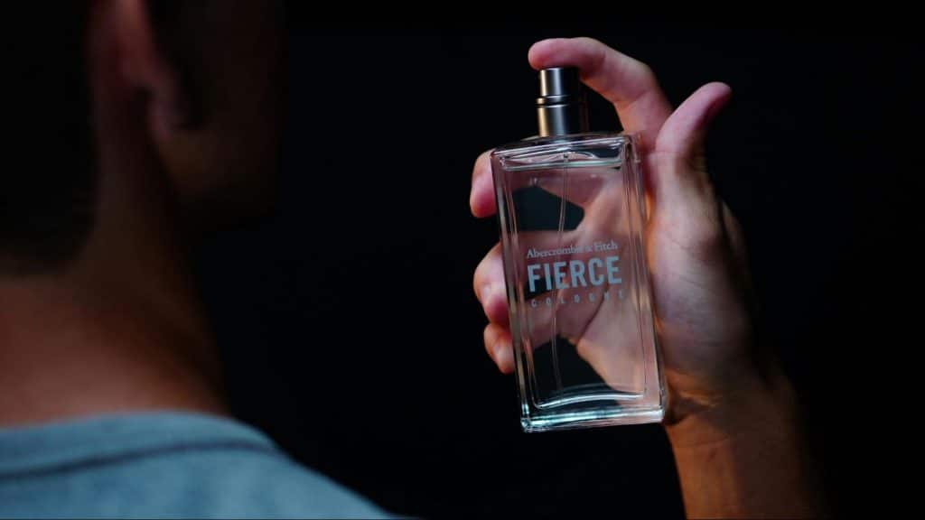A man spraying a perfume.