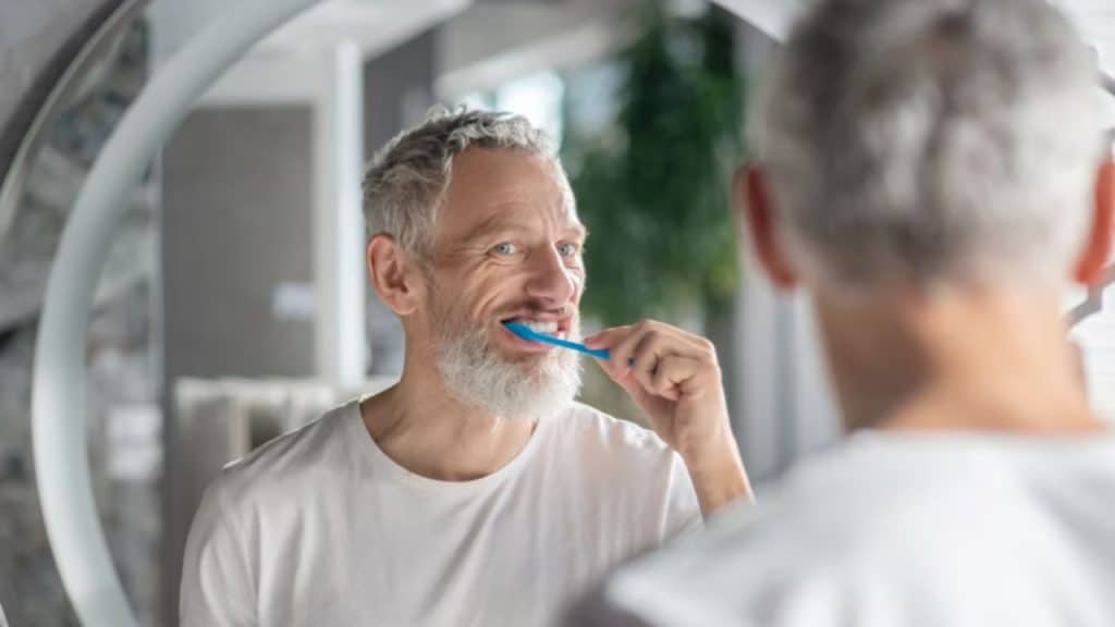 Man practicing oral hygiene to support long term health