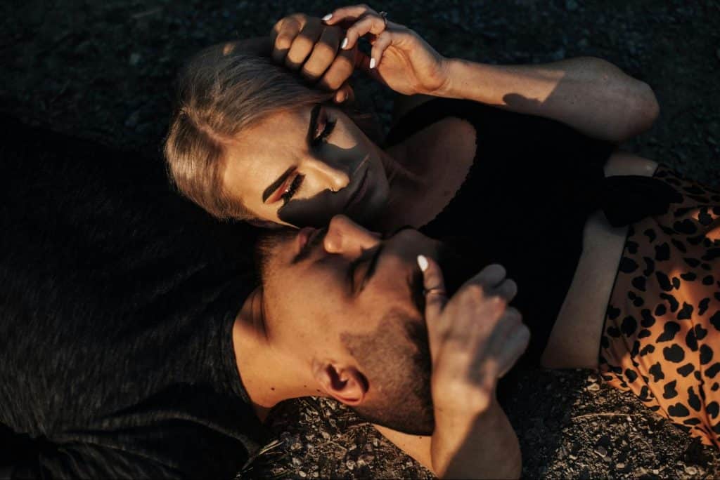 A man and woman laying on each other’s shoulder as a sign of trust