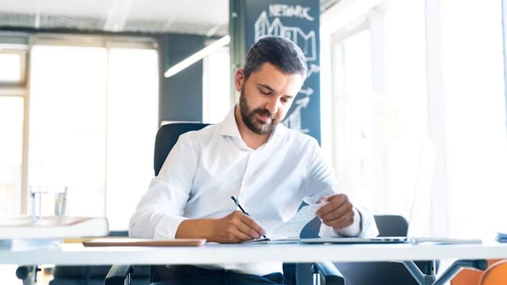 Man reflecting in a journal, embracing emotional strength