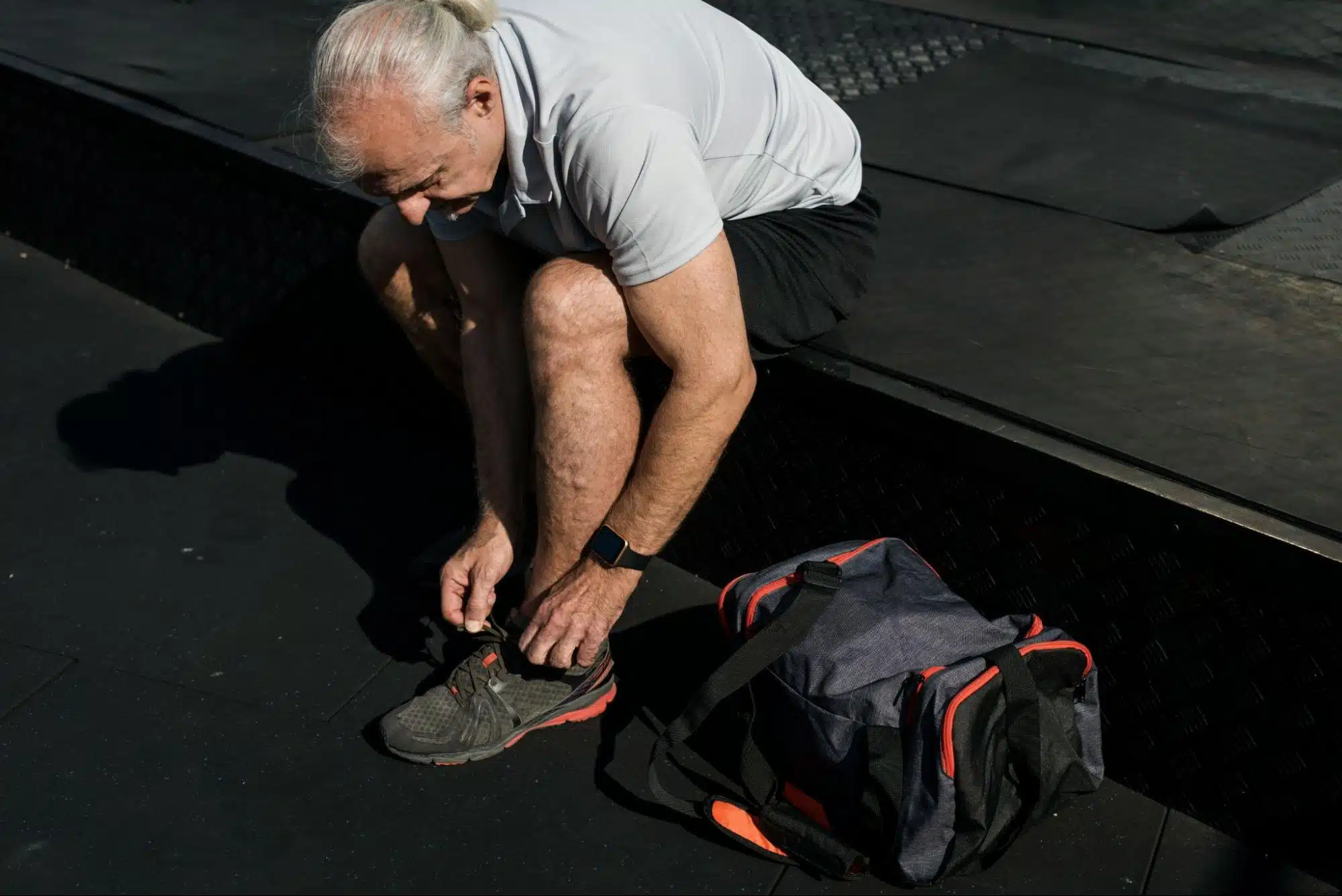 A man with a gym bag on his side.