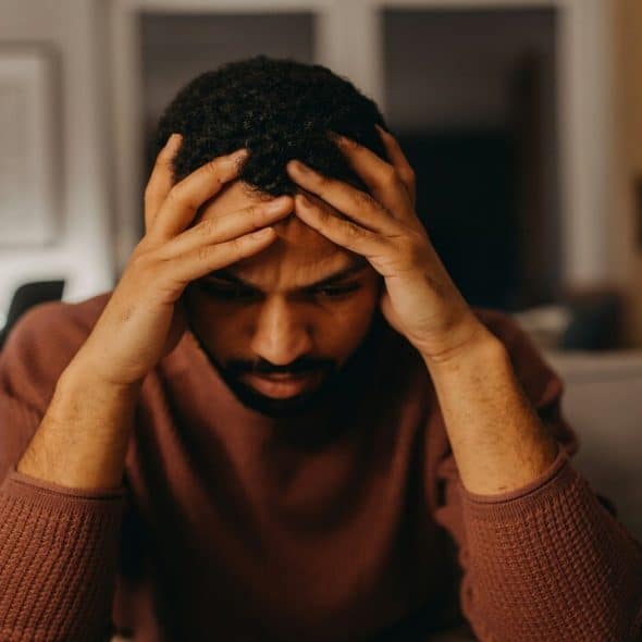 A man looking confused at home.