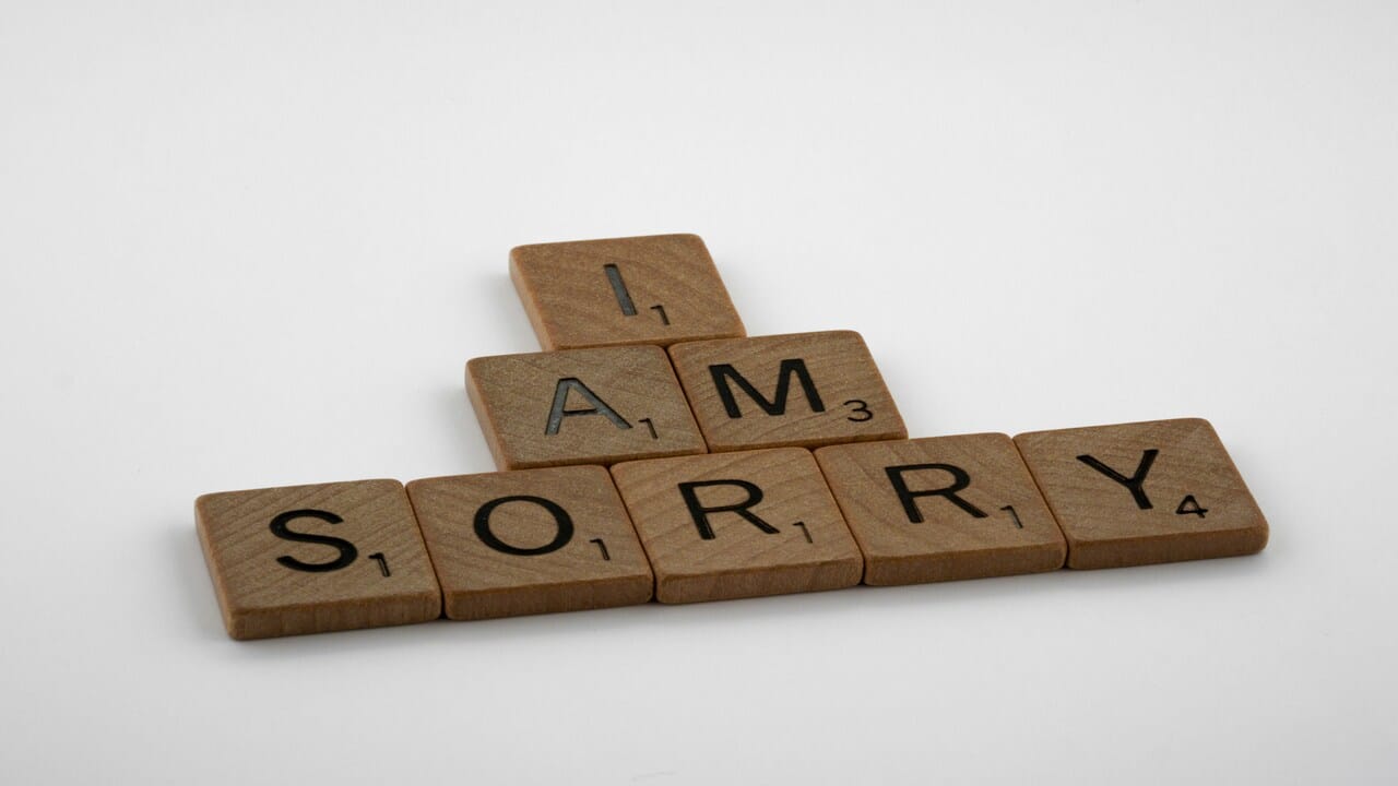 Wooden blocks spelling out “I am sorry”.