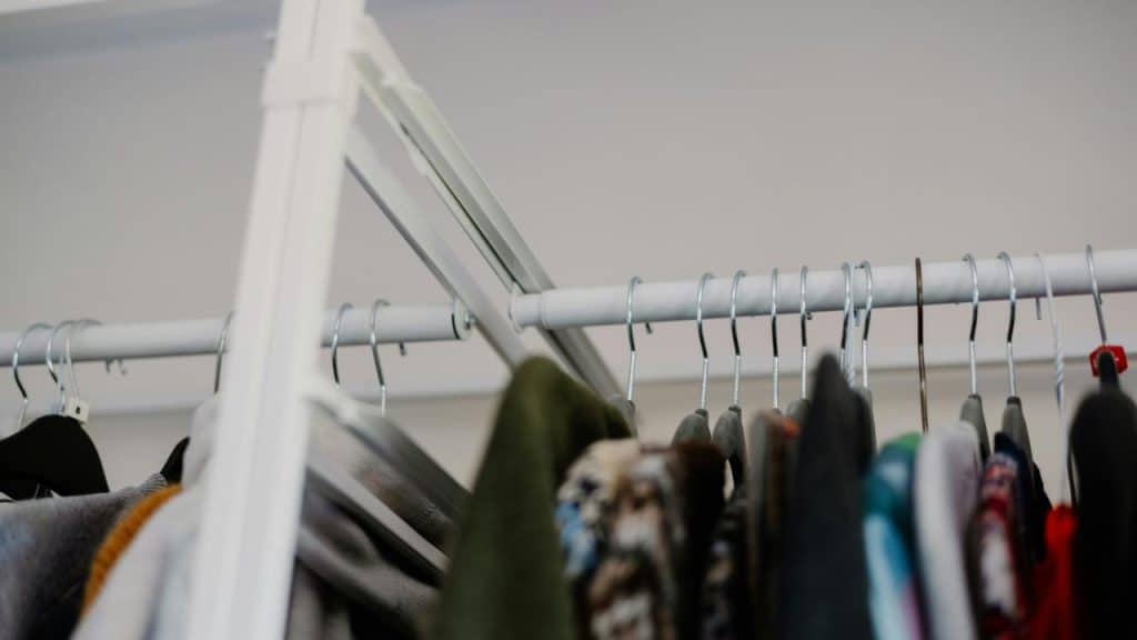 A rack of clothes hanging on metal hangers.