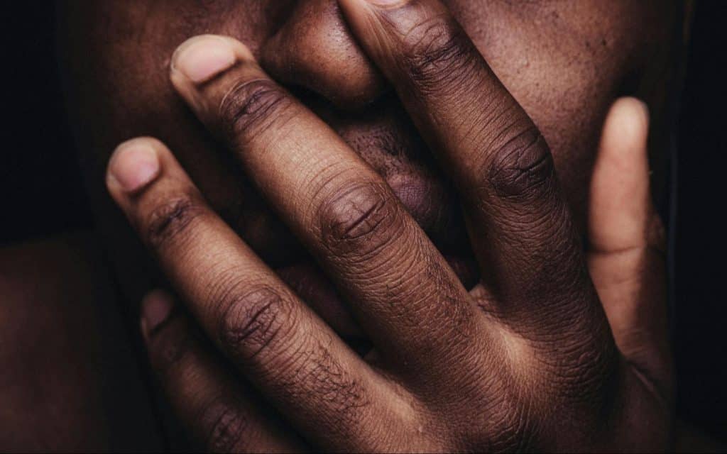 A man covering a mouth.