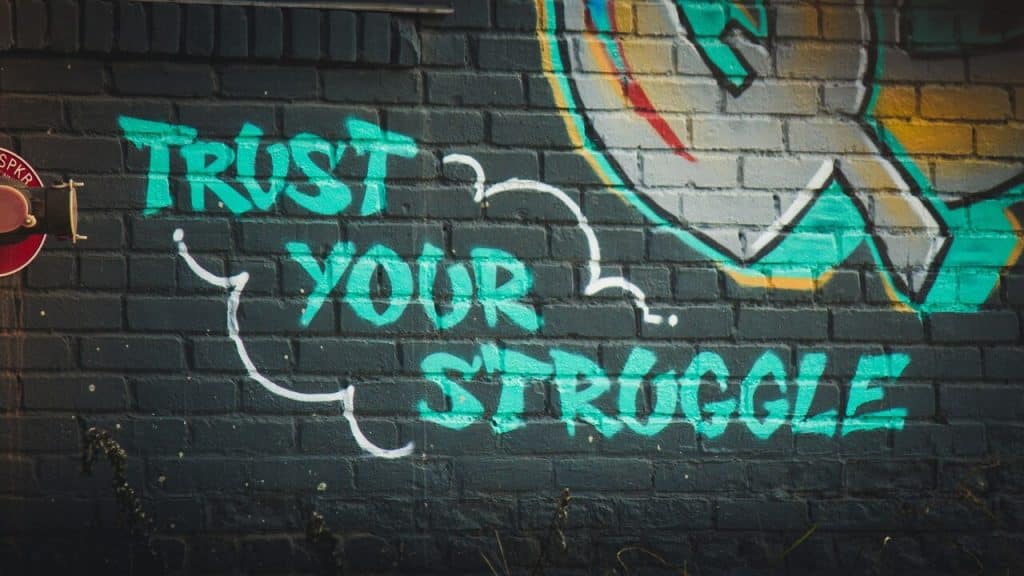 A graffiti of the quote “trust your struggle”