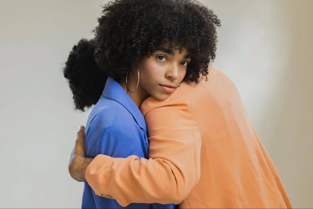 A man getting hugged by a man