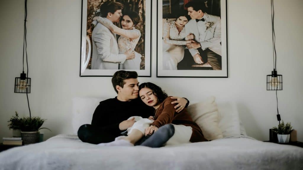 A couple cuddling in bed