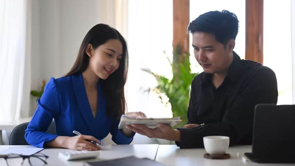 Man and woman creating a financial vision sheet together.