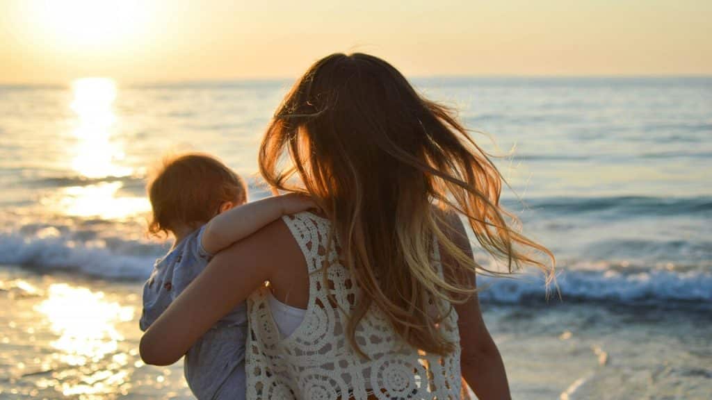 A woman carrying her baby