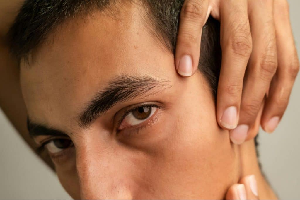 A man cleaning his ears.