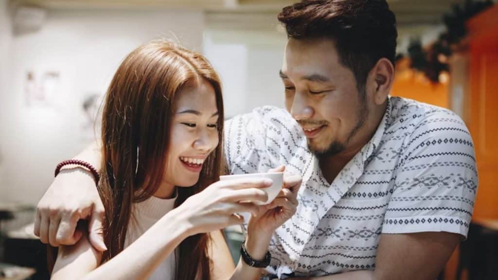 Man surprising his partner with her favorite drink