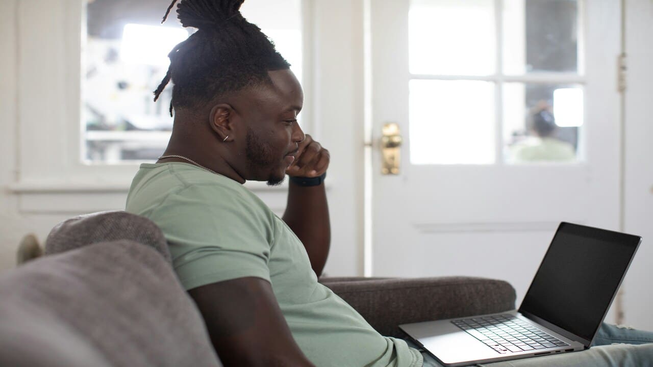A man thinking in front of the laptop.