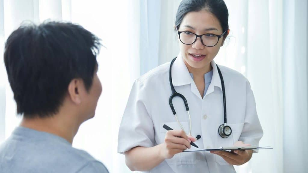 A doctor with a stethoscope consulting a patient.