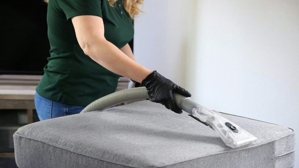 A person cleaning her couch