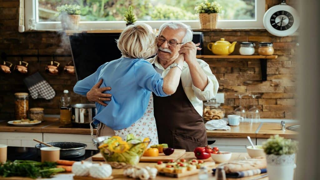 A couple slow dancing in the kitchen