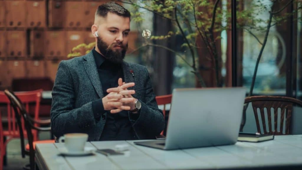 Man appearing fatigued at work despite drinking coffee.