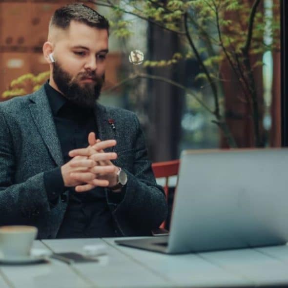 Man appearing fatigued at work despite drinking coffee.
