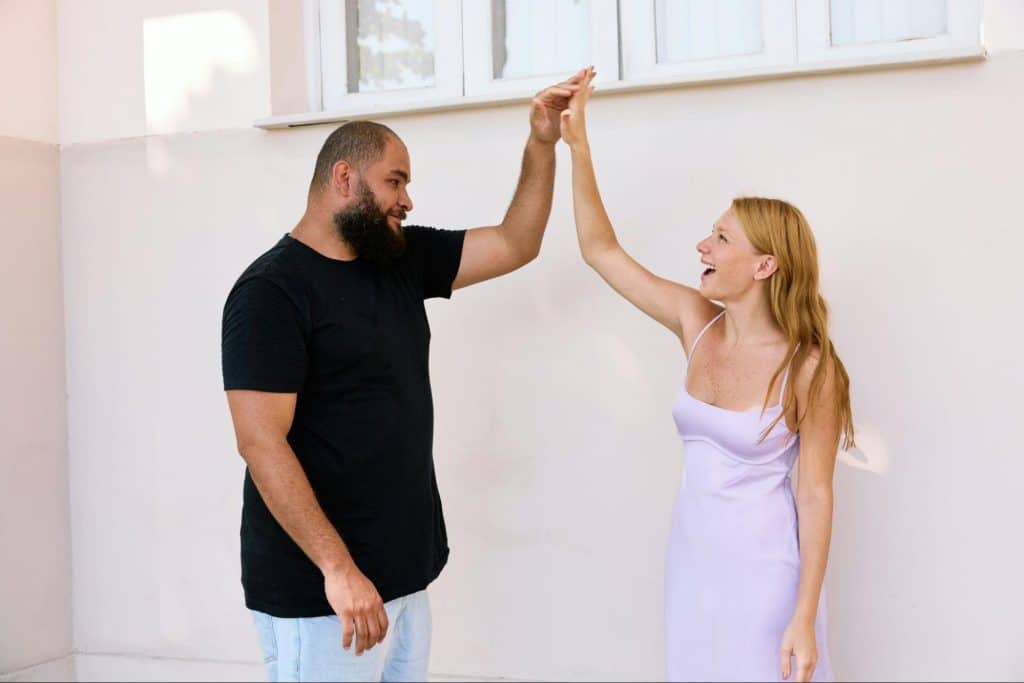 A man and woman touching hands