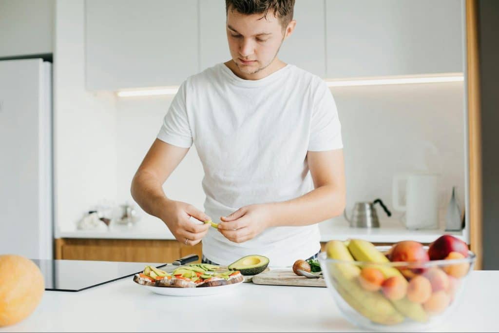 A picture of a man preparing a healthy foods.