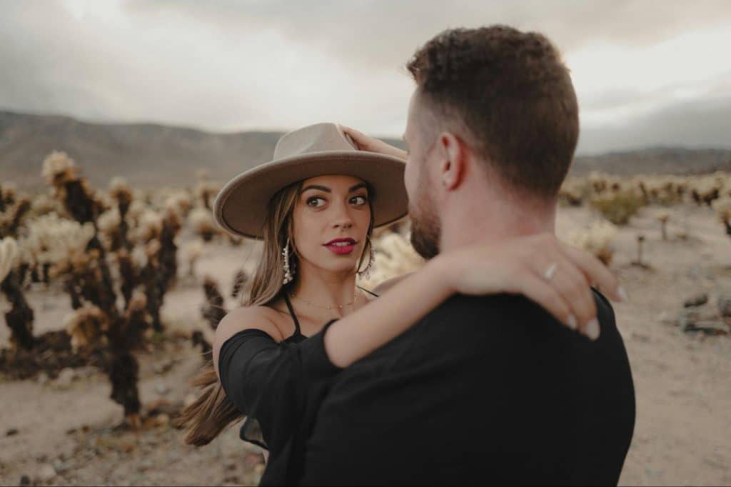 A woman getting affectionate to a man.
