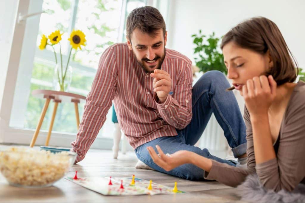 A man and woman playing a board game together.