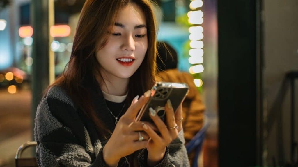 Woman engaging in thoughtful texting conversation with a man