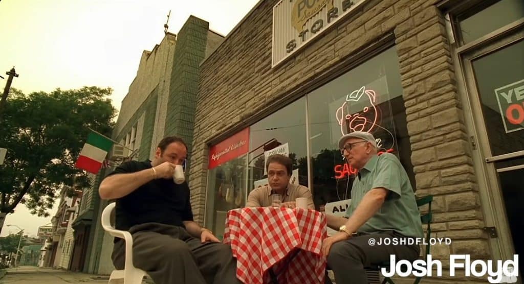 Three men eating outside.
