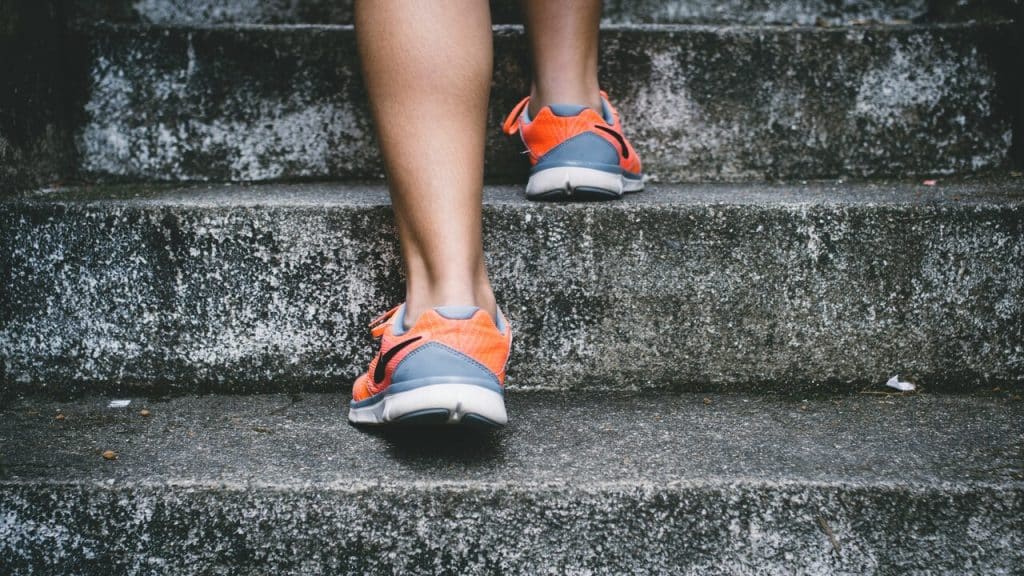 A person walking up the concrete stairs