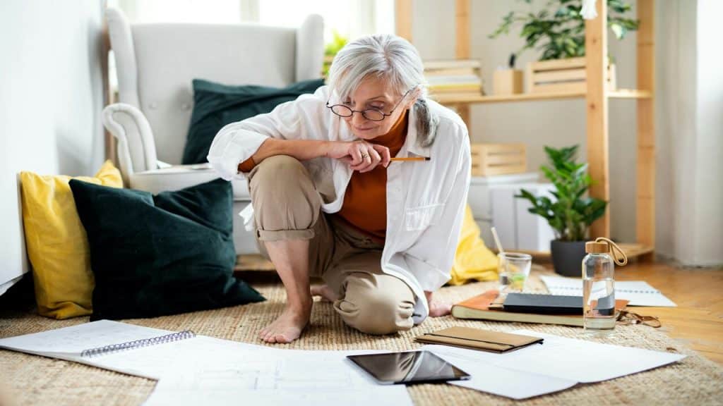 An older woman looking at blueprints
