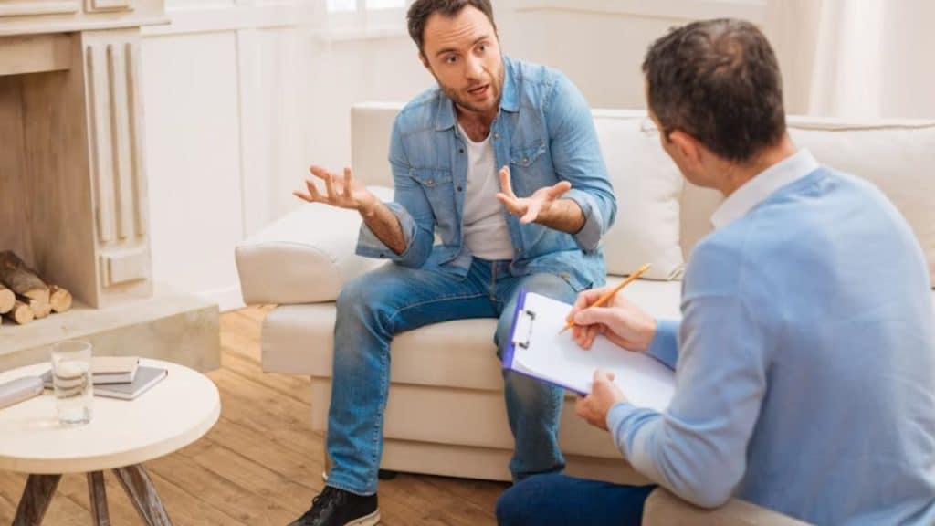 A man in a solo therapy session focused and open