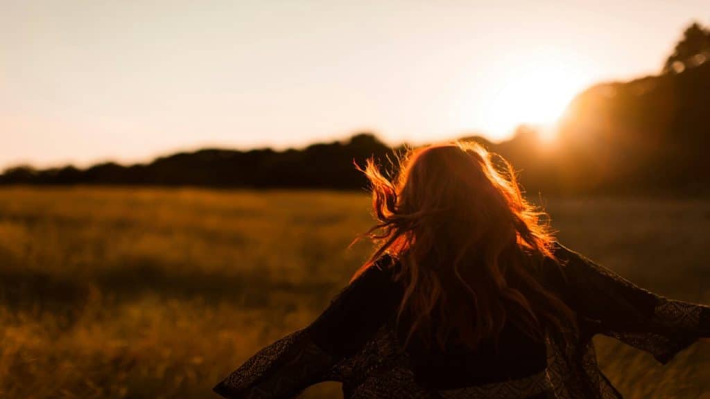 A woman frolicking in the field