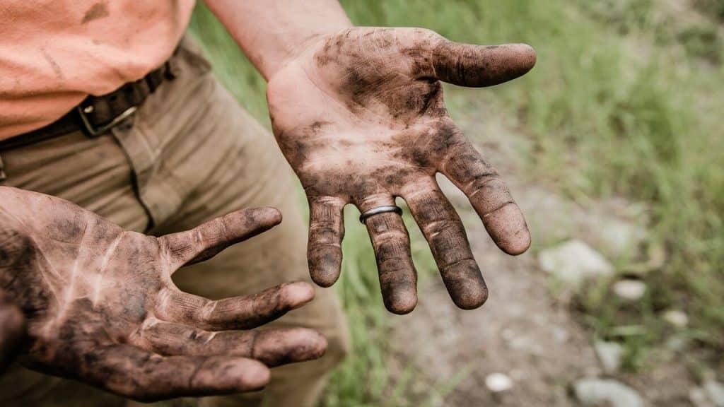 A farmer’s hands covered with dirt