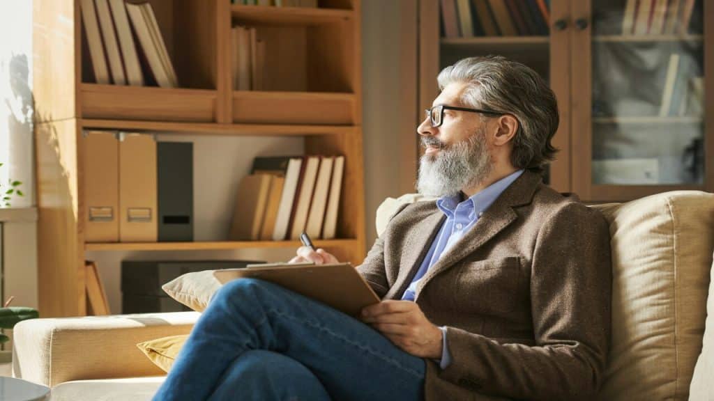 An older man studying at home