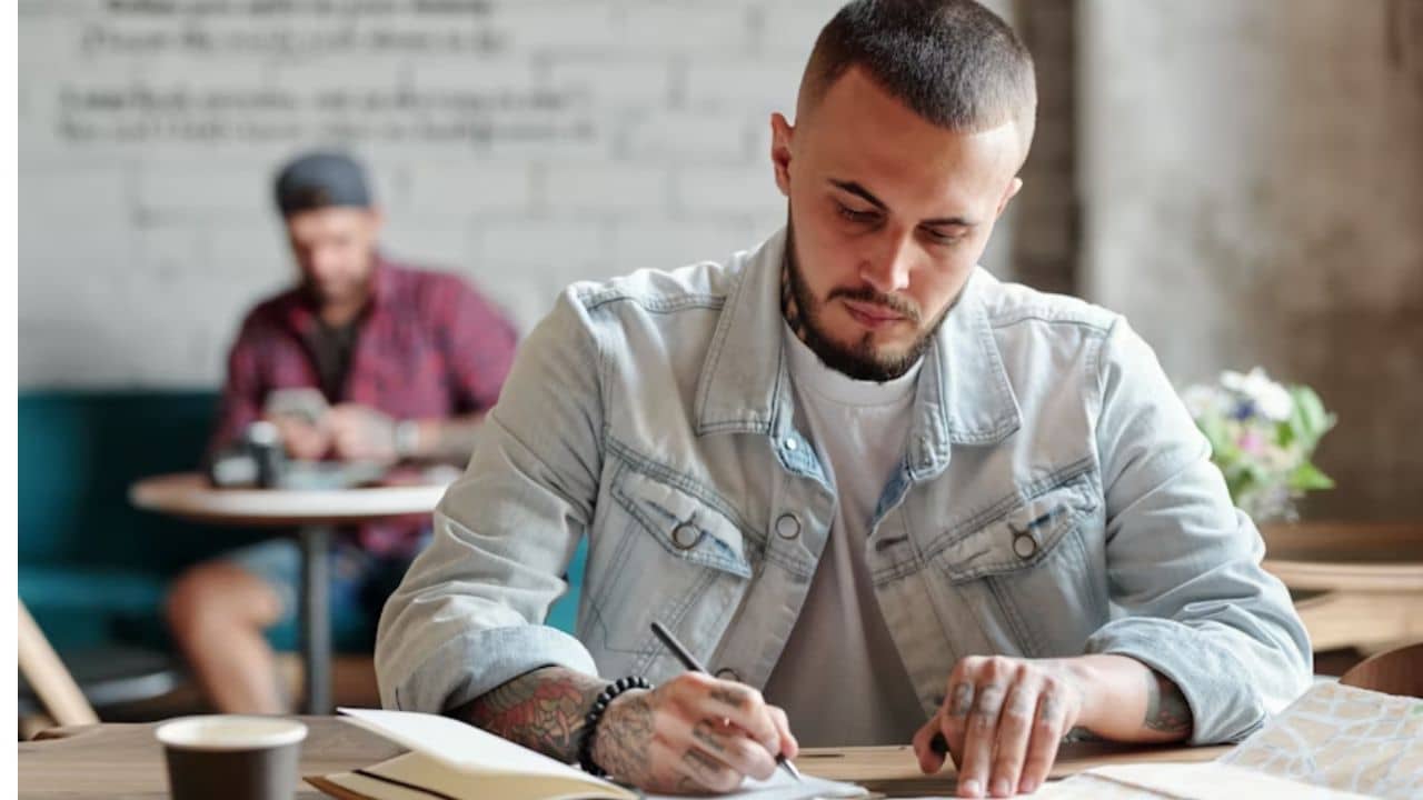 A man writing down relationship values at a desk.