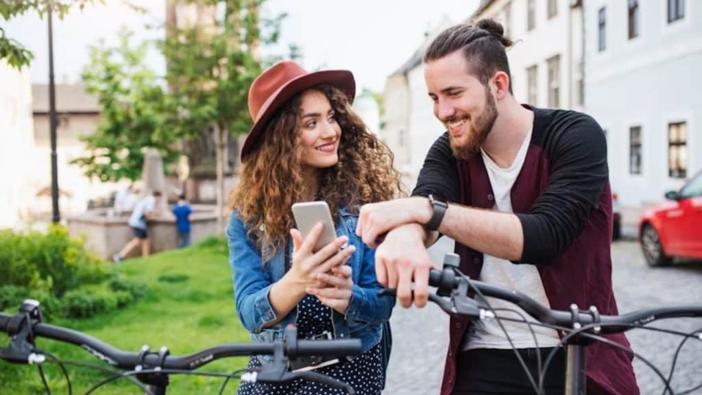 A man and woman laughing during a relaxed exchange in a park