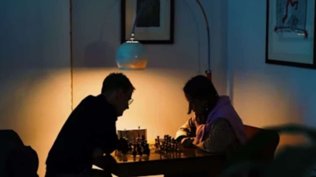 Couple facing off in a friendly game of chess.