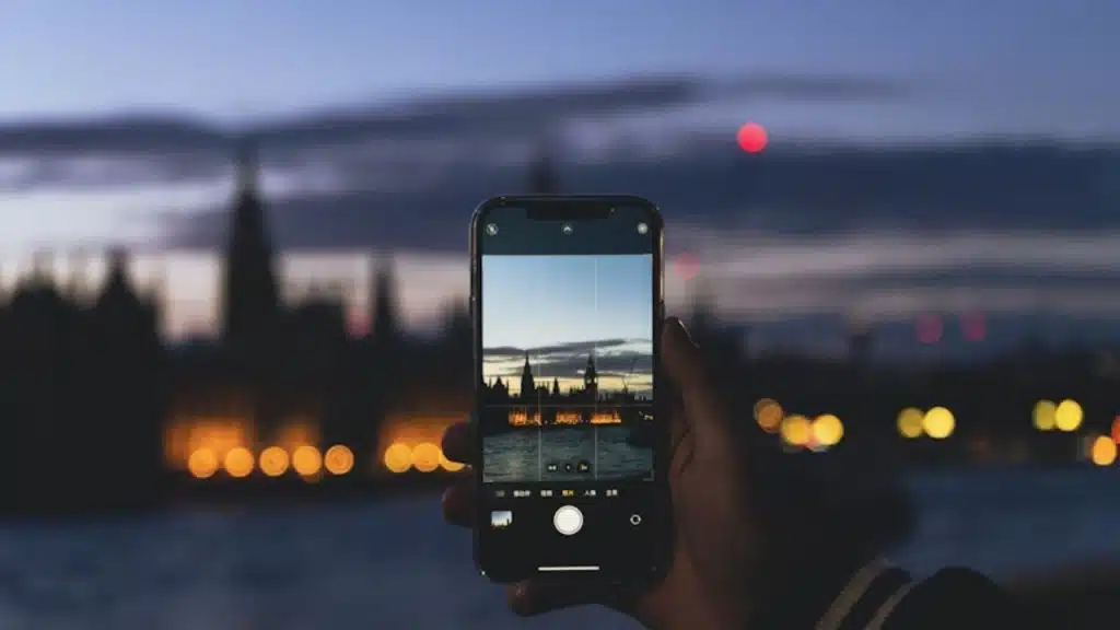 Man taking a photo and sending a thoughtful, personal message to his partner.