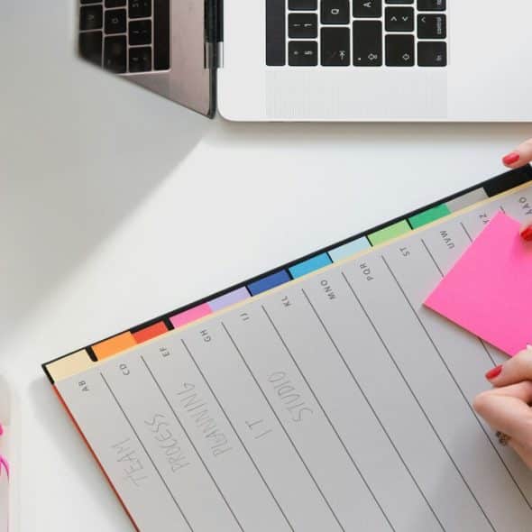 A person preparing her weekly planner
