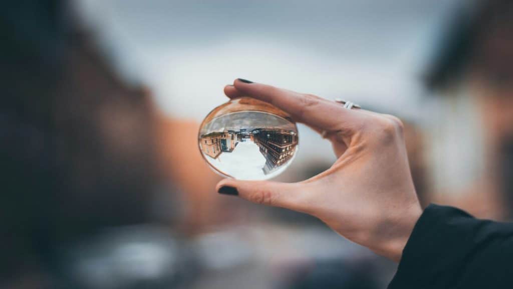 A woman holding a clear glass ball