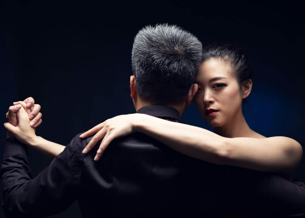 A woman hugging a man