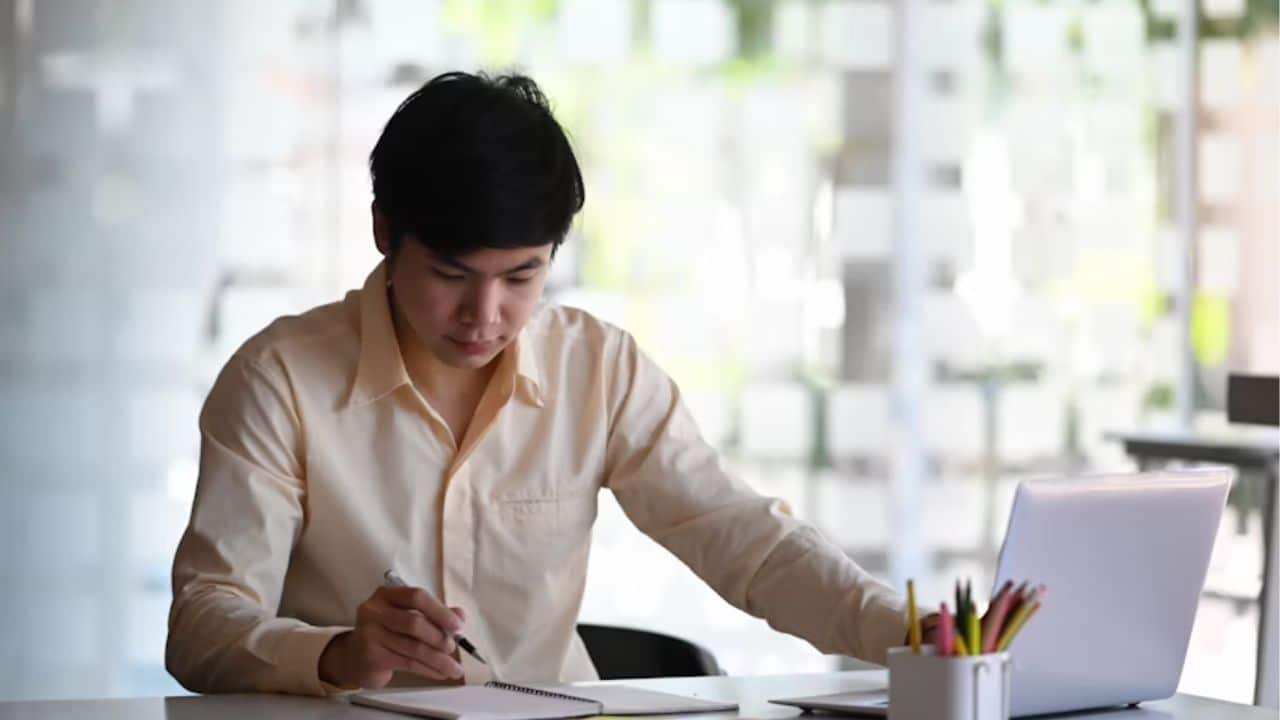 A man journaling quietly on his notebook.