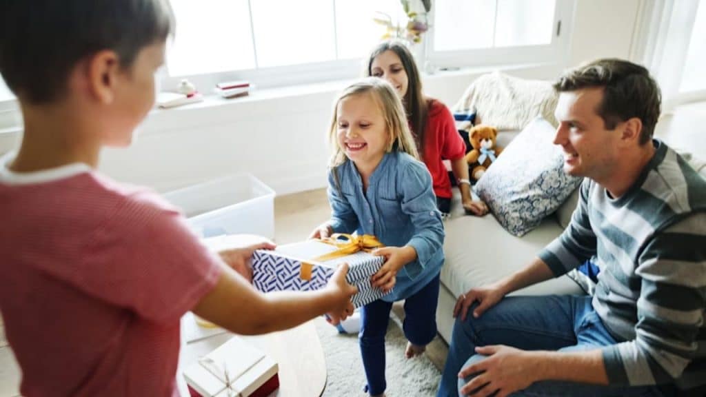 Friendly father welcoming his child’s friends at home.