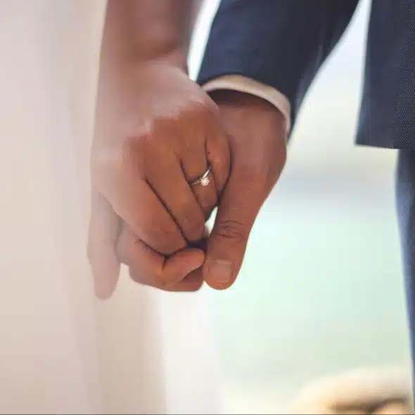A married couple holding hands
