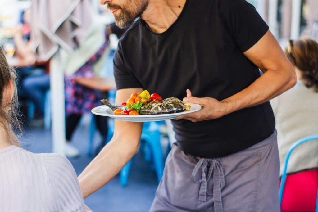 A man holding a plate of food.