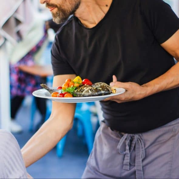A man holding a plate of food.