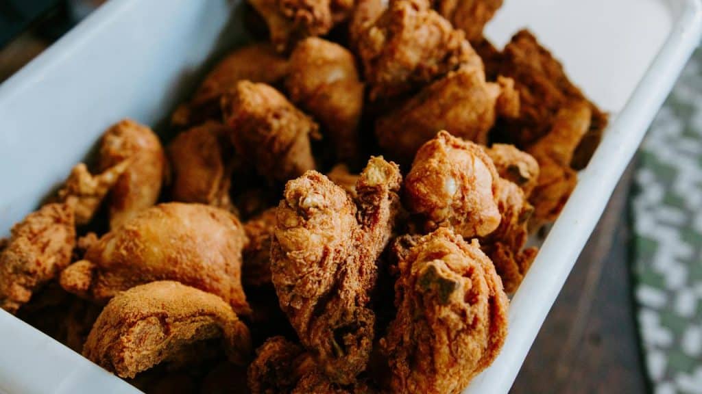 A container of crispy fried chicken pieces.