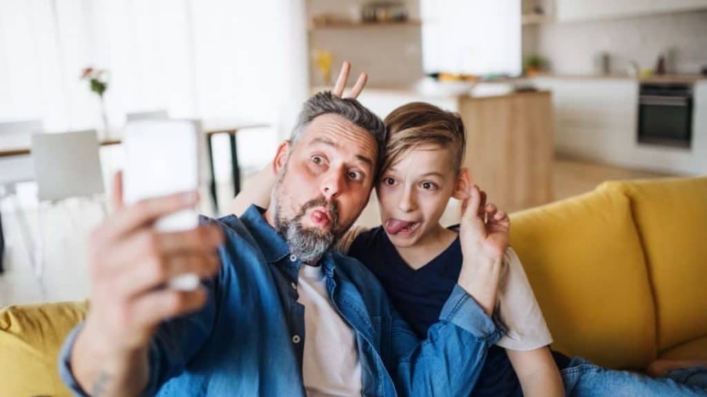 Father and teen sharing a joyful moment filled with laughter
