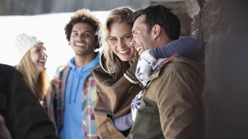 Man smiling and engaging with her friends