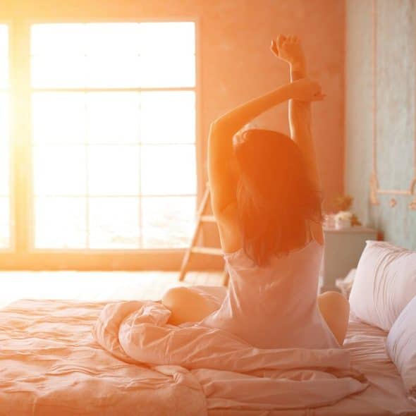 A woman waking up in the morning.